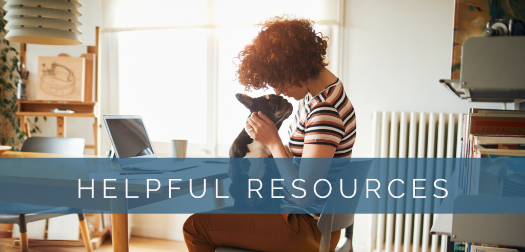 image of a woman at a table with a dog in her lap with text overlaid that says "Helpful resources"