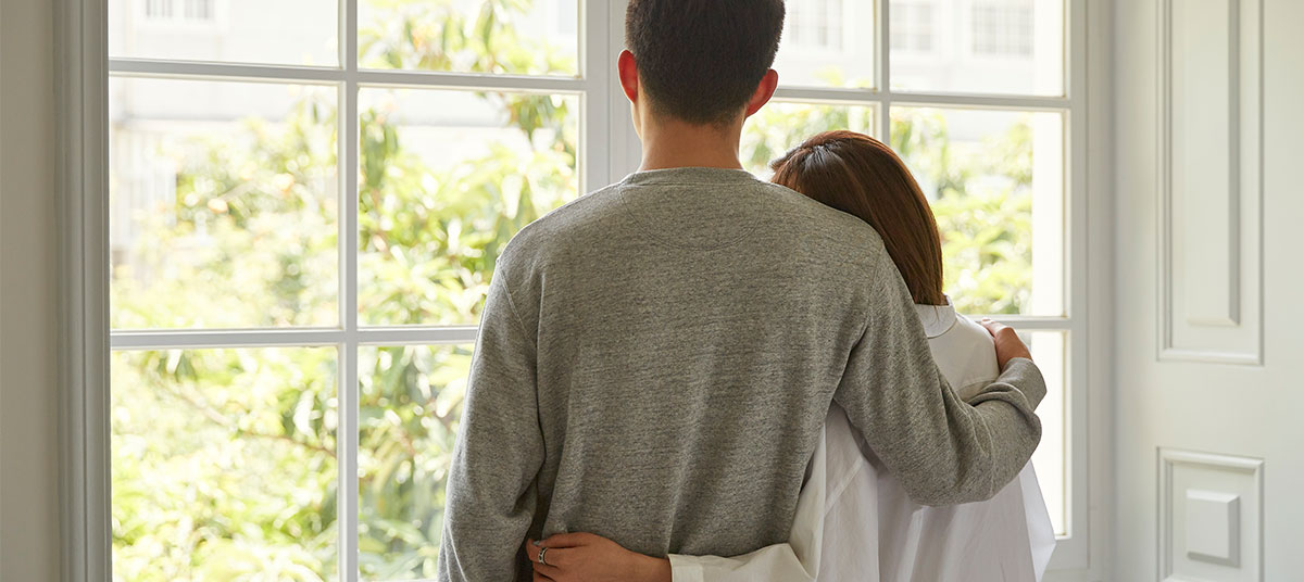 picture of a mother and son hugging and looking out the window